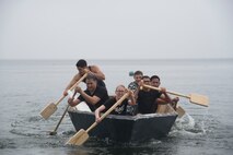A U.S. Navy team participates in a regatta competition during the first Team Misawa Resilient Relationships and Appreciation Day at Misawa Air Base, Japan, Aug. 18, 2017. Teams worked together, crafting their own boats to race during an obstacle course. The 35th Fighter Wing Chapel Corps coordinated the event as a morale booster testing their pillars of Comprehensive Airman Fitness—mental, physical, social and spiritual—which promoted a sense of community and equip personnel to perform optimally. (U.S. Air Force photo by Senior Airman Sadie Colbert)