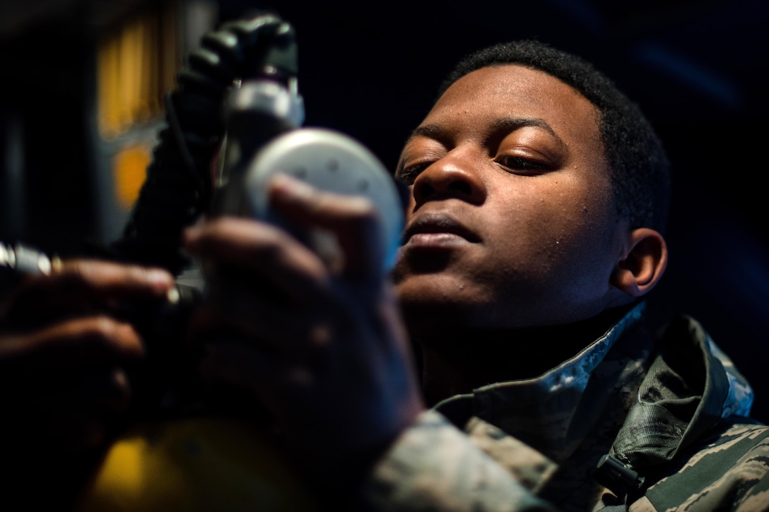 An airman completes pre-flight checks on a C-5M Super Galaxy.