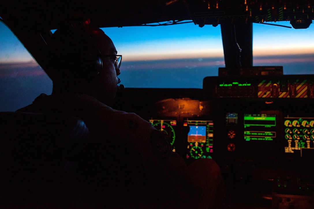 A pilot flies a C-5M Super Galaxy aircraft over the Atlantic Ocean.