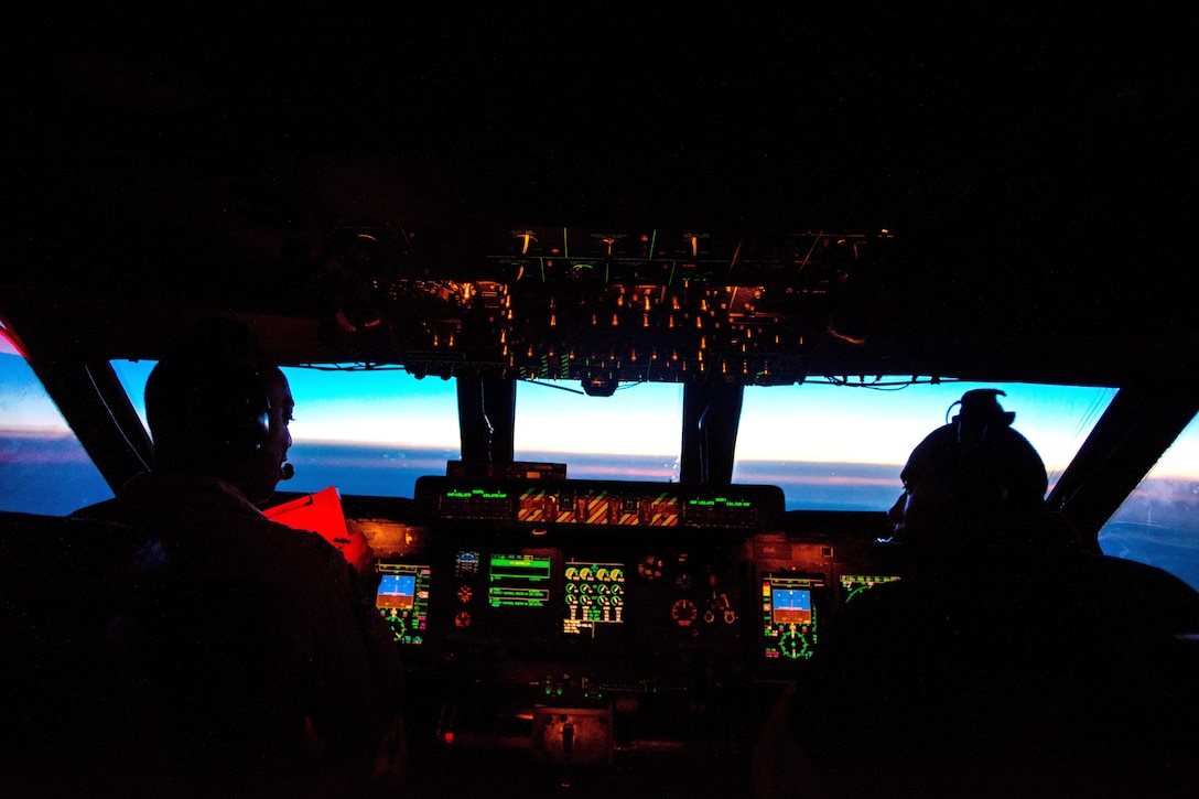 Pilots fly a C-5M Super Galaxy aircraft over the Atlantic Ocean.