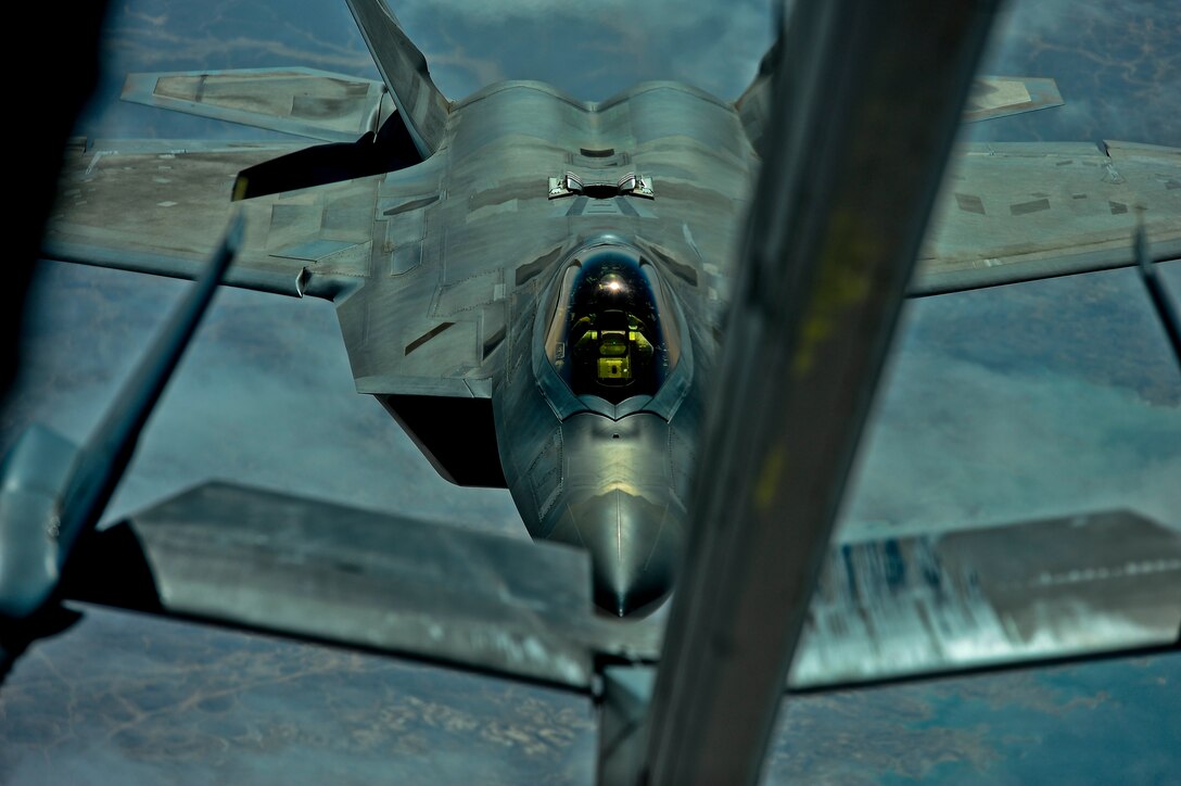 A U.S. Air Force F-22 assigned to the 380th Air Expeditionary Wing, Al Dhafra Air Base, United Arab Emirates prepares to receive fuel from a KC-10 Extender over Syria March 2, 2018. The F-22 possesses a sophisticated sensor suite allowing the pilot to track, identify, shoot and kill air-to-air threats before being detected. 
 (U.S. Air Force photo by Tech. Sgt. Anthony Nelson Jr.)
