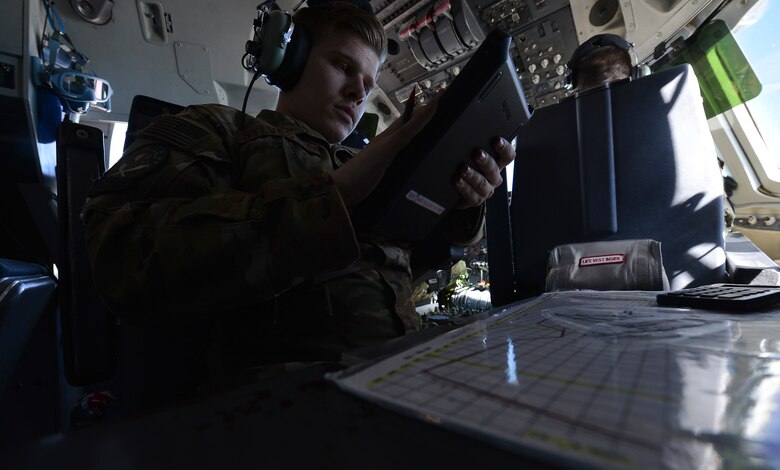 U.S. Air Force Senior Airman Jadon Sylvester, flight engineer, reads air refueling speeds over Syria during a mission in support of Operation Inherent Resolve, March 2, 2018. A KC-10 Extender flight engineer is responsible for ensuring the in flight operation of key aircraft communication, navigation, and weight systems to enable the crew to provide a tactical refueling capability during combat missions for U.S. and Coalition forces operating in Iraq and Syria.
 (U.S. Air Force photo by Tech. Sgt. Anthony Nelson Jr.)