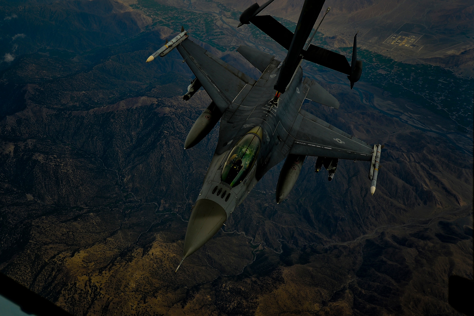 A U.S. Air Force F-16 Fighting Falcon assigned to the 455th Air Expeditionary Wing, Bagram Airfield, Afghanistan receives fuel over Afghanistan from a KC-10 Extender, March 9, 2018.
 The F-16 provides cover from above for Afghan and coalition forces on the ground, deterring insurgent activity and allowing friendly freedom of movement for troops. 
 (U.S. Air Force photo by Tech. Sgt. Anthony Nelson Jr.)
