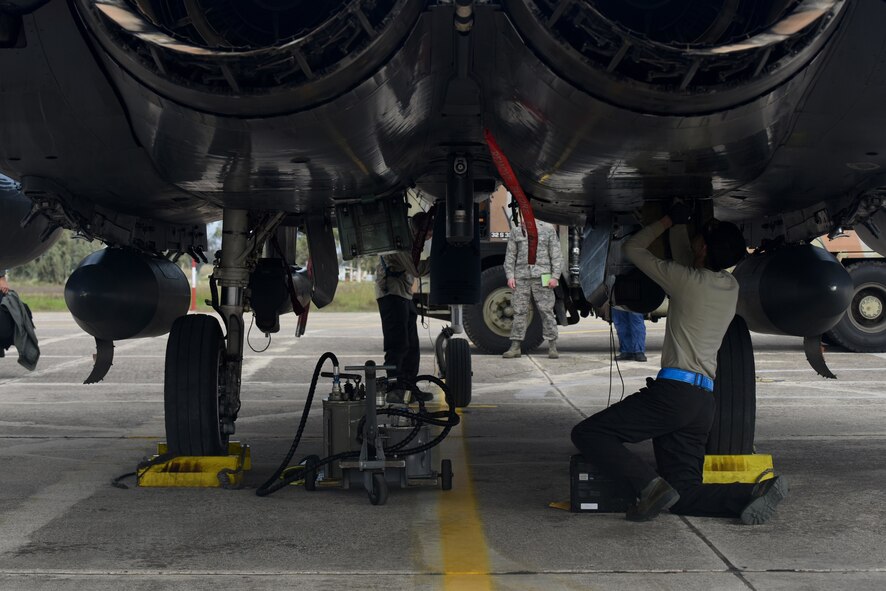 An Airman assigned to the 492nd Aircraft Maintenance Unit performs post-flight checks on an F-15E Strike Eagle at Andravida Air Base, Greece, March 7. The F-15s are scheduled to participate in INIOHOS 18, a Hellenic Air Force-led multinational exercise that enhances interoperability, capabilities and skills between allied and partner air forces. (U.S. Air Force photo/Airman 1st Class Eli Chevalier)