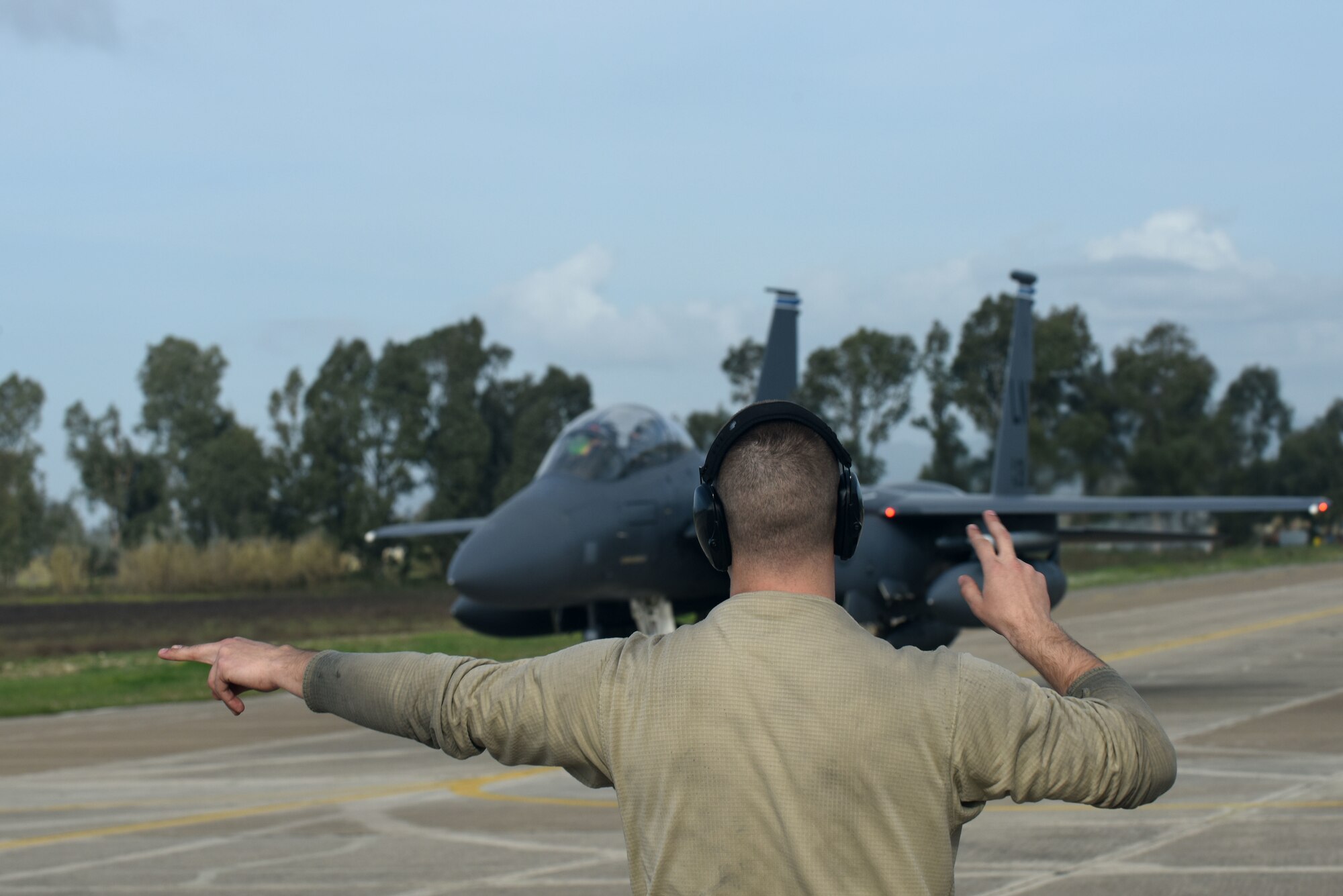 An Airman assigned to the 492nd Aircraft Maintenance Unit marshals an F-15E Strike Eagle, assigned to the 492nd Fighter Squadron from Royal Air Force Lakenheath, England, at Andravida Air Base, Greece, March 7. The 492nd FS is scheduled to participate in INIOHOS 18, a Hellenic Air Force-led, large-force flying exercise that is slated to involve seven countries and over 50 aircraft. (U.S. Air Force photo/Airman 1st Class Eli Chevalier)