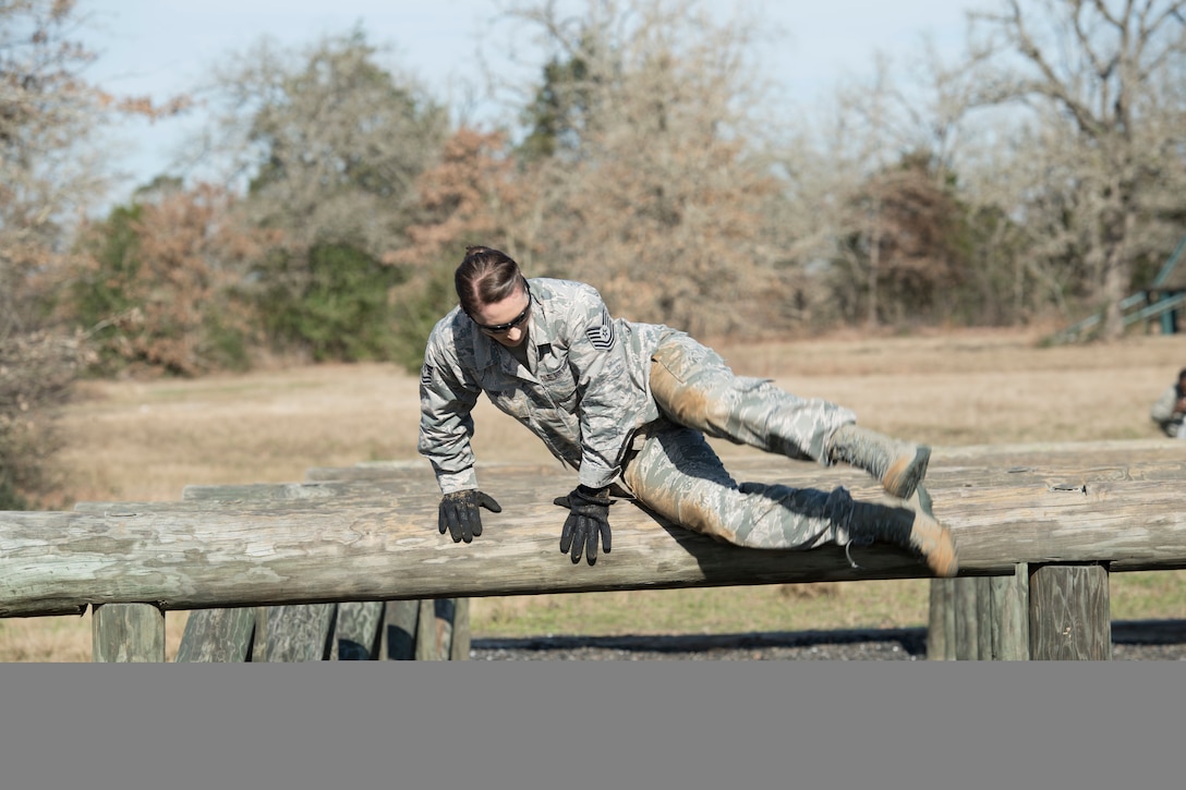Air Force Tech. Sgt. Jennifer Brown, an education and training specialist with the Texas Air National Guard’s 273rd Cyber Operations Squadron, jumps over an obstacle during the 2018 Best Warrior Competition near Bastrop, Texas, March 1, 2018. Texas Air National Guard photo by Staff Sgt. Agustin Salazar