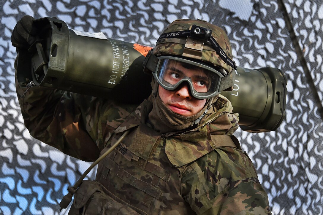 Spc. Daniel Nieves carries a propellant charge.