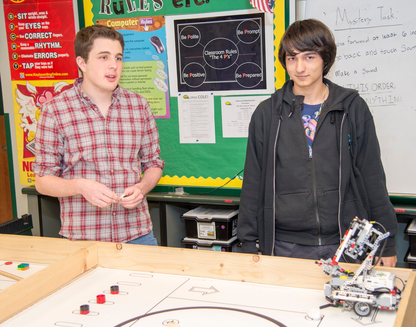 Cole High School students Mitchell Hafer (left) and Henry Yowell (right) stand beside the robot they designed and built that won first place at the Texas Computer Educators Association robotics area contest Jan. 20. Hafer and Yowell, along with Aydin Chewning (not pictured) are members of the Cole robotics team that will compete in TCEA State Robotics Challenge Contest April 7 at Hutto High School, near Austin.