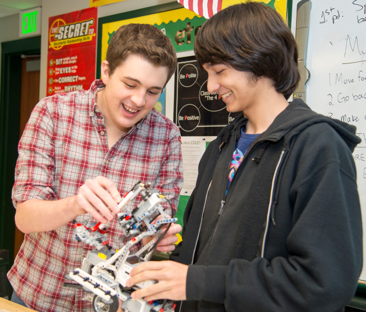 Cole High School students Mitchell Hafer (left) and Henry Yowell (right) make adjustments to their robot while they prepare to test it in a classroom. Hafer and Yowell, members of the Cole robotics team, helped build and design the robot whose performance earned first place for Cole at the Texas Computer Educators Association, or TCEA, robotics area contest Jan. 20. As a result of their first-place showing, the team will compete in the TCEA State Robotics Challenge Contest April 7 at Hutto High School, near Austin.