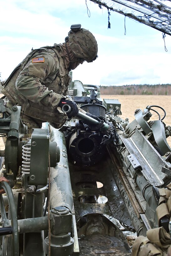 A soldier prepares a M777 howitzer.
