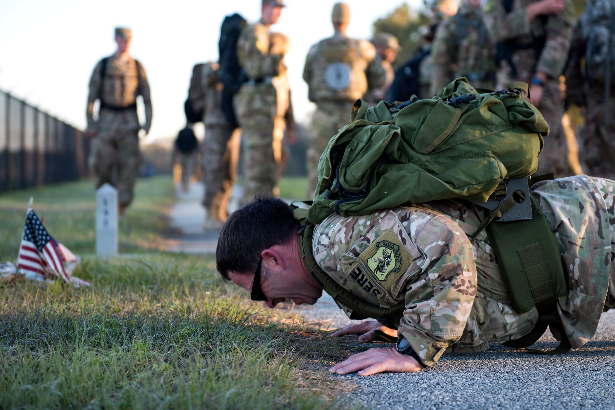 Tech. Sgt. Daniel Wiggins, 347th Operations Support Squadron (OSS) Survival, Evasion, Resistance, Escape specialist, performs pushups as part of a ruck march during a Comprehensive Airman Fitness (CAF) Day, March 9, 2018, at Moody Air Force Base, Ga. During CAF Day, the 347th OSS focused on the physical domain, bolstering resiliency through team building activities. (U.S. Air Force photo by Airman 1st Class Erick Requadt)