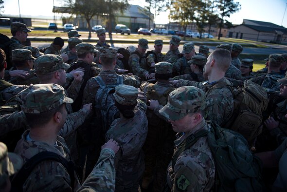 Airmen from the 347th Operations Support Squadron (OSS) rally together after a ruck march during a Comprehensive Airman Fitness (CAF) Day, March 9, 2018, at Moody Air Force Base, Ga. During CAF Day, the 347th OSS focused on the physical domain, bolstering resiliency through team building activities. (U.S. Air Force photo by Airman 1st Class Erick Requadt)