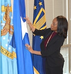 Imani Mitchell adjusts flags.