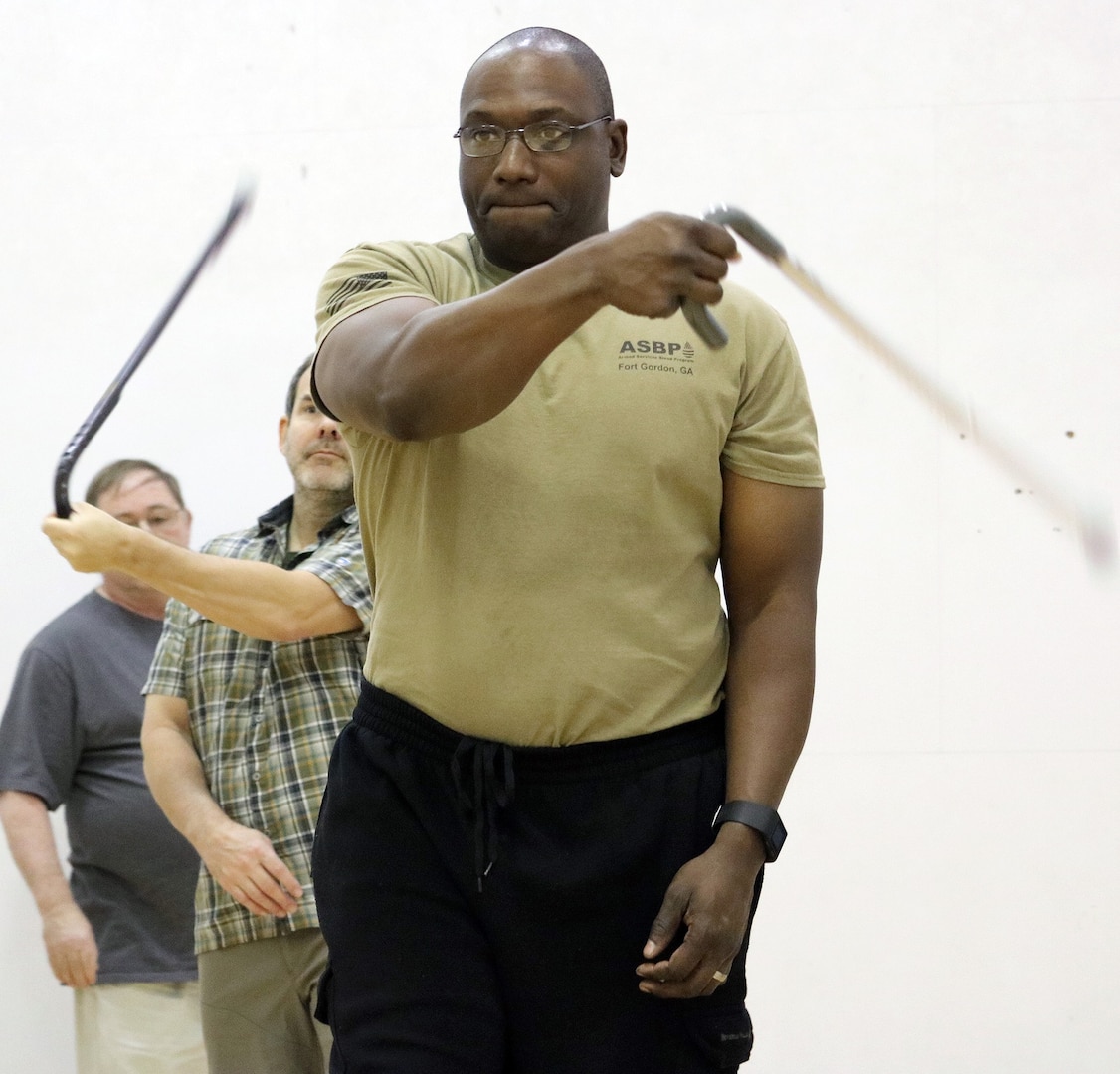 Chief Warrant Officer 3 Robert Hunter, Brooke Army Medical Center Warrior Transition Battalion, puts his cane self-defense tactics to use during a training session Feb. 3, in the Jimmy Brought Fitness Center, Joint Base San Antonio-Fort Sam Houston. Hunter was one of 40 active duty service members, wounded warriors, veterans and family members who attended the three-hour session to learn the intricacies of cane self-defense.