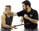 Master Phillip Lobo, a fighting and fitness instructor, demonstrates a cane self-defense strike technique on instructor Evan Payne, while assisting the Warrior Cane Project train 40 active duty service members, wounded warriors, veterans, and family members in cane self-defense tactics Feb. 3 at the Jimmy Brought Fitness Center at Joint Base San Antonio-Fort Sam Houston. Lobo and Payne, along with several other instructors provided a 3-hour session teaching the intricacies of cane self-defense.