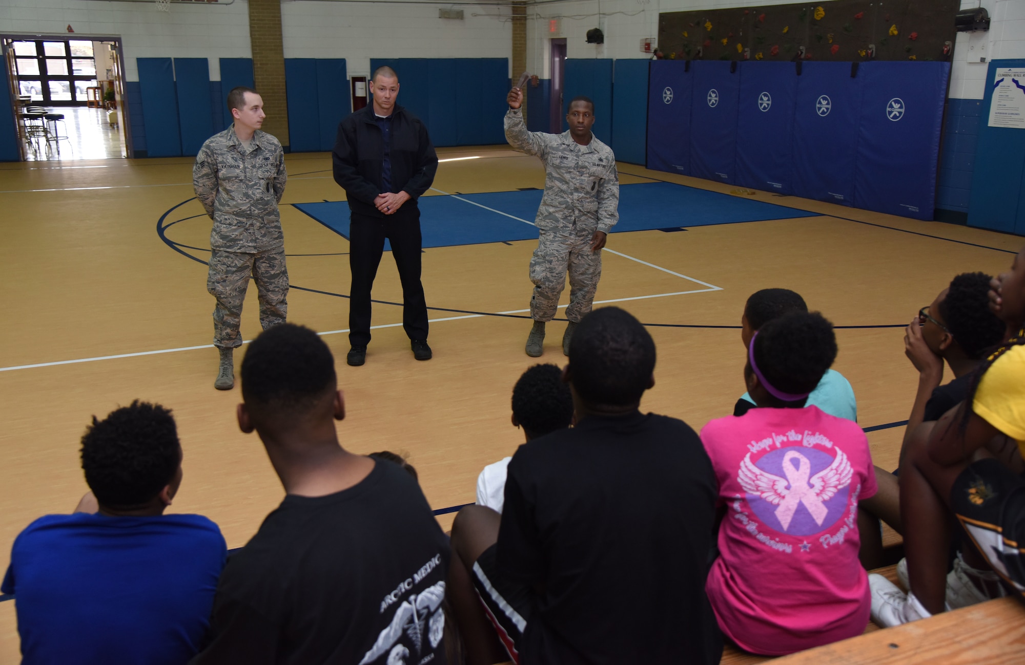 Senior Airman James Vaughn, 81st Security Forces Squadron training instructor, Justin Depew, 81st SFS patrolman, and Master Sgt. Cordarius Lewis, 81st SFS operations NCO in charge, discuss safety procedures during lockdown training at the Keesler Youth Center March 8, 2018, on Keesler Air Force Base, Mississippi. In lieu of recent active shooter incidents in schools, defenders conducted the training to discuss school safety during a potential active shooter situation. (U.S. Air Force photo by Kemberly Groue)