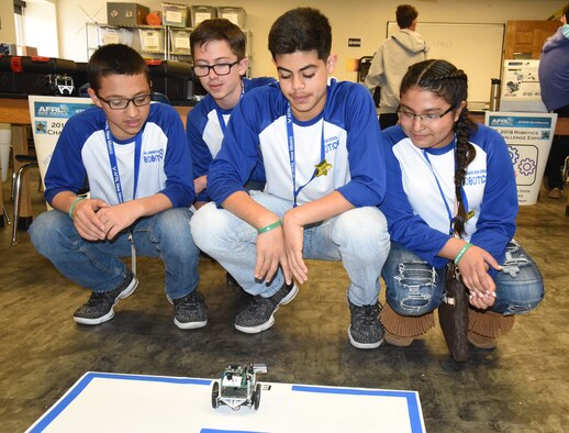 Brandon Truvino, Brandon Doss, Alex Carreon and Karen Sauceda test their robot programming on a simple maze at the Air Force Research Laboratory's La Luz Academy Robotic Challenge Expo March 9 at Kirtland. The seventh grade students are one of eight teams from Jal Junior High that competed at the annual event.