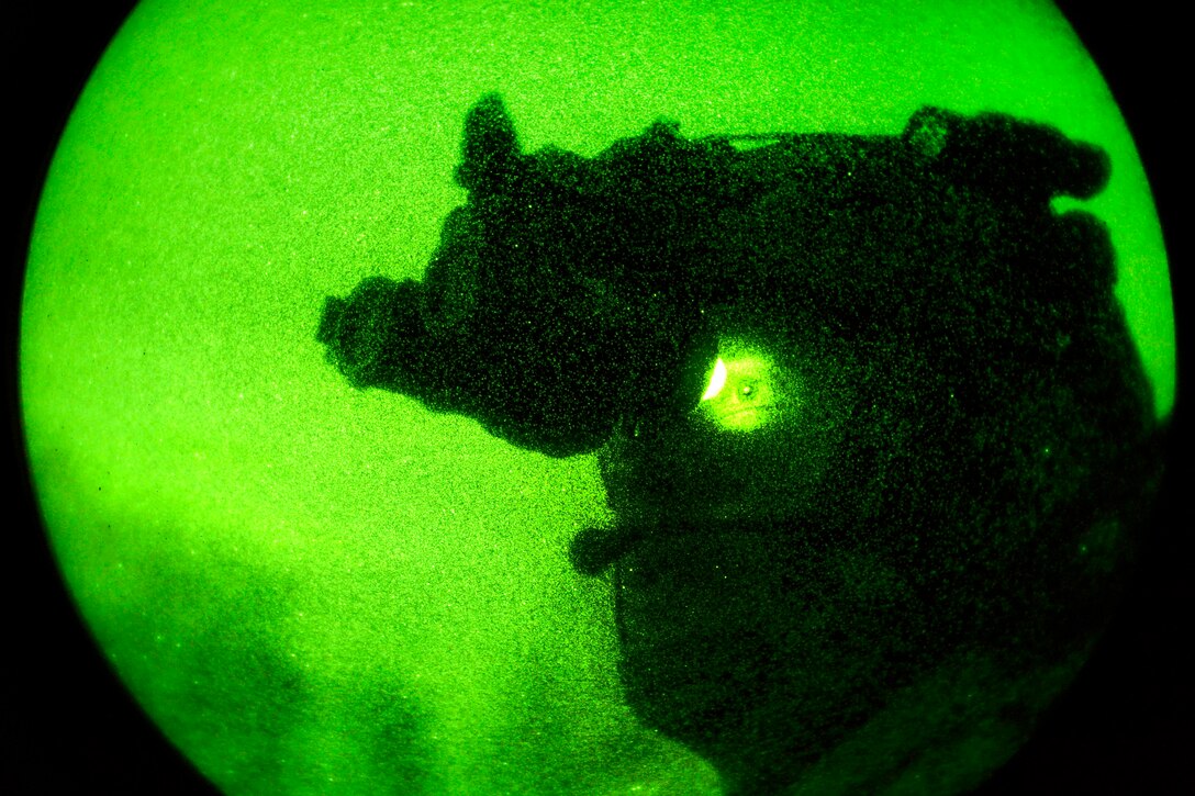 A Special Operation soldier looks through his night goggles
