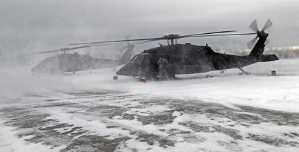 Alaska National Guard Soldiers with Alpha Company, 1st Battalion, 207th Aviation Regiment prepare to embark from the Bryant Army Airfield on Joint Base Elmendorf-Richardson, Alaska, in their UH-60 helicopters in support of a training mission several miles north of the Alaskan coastline Mar. 4, 2018.
