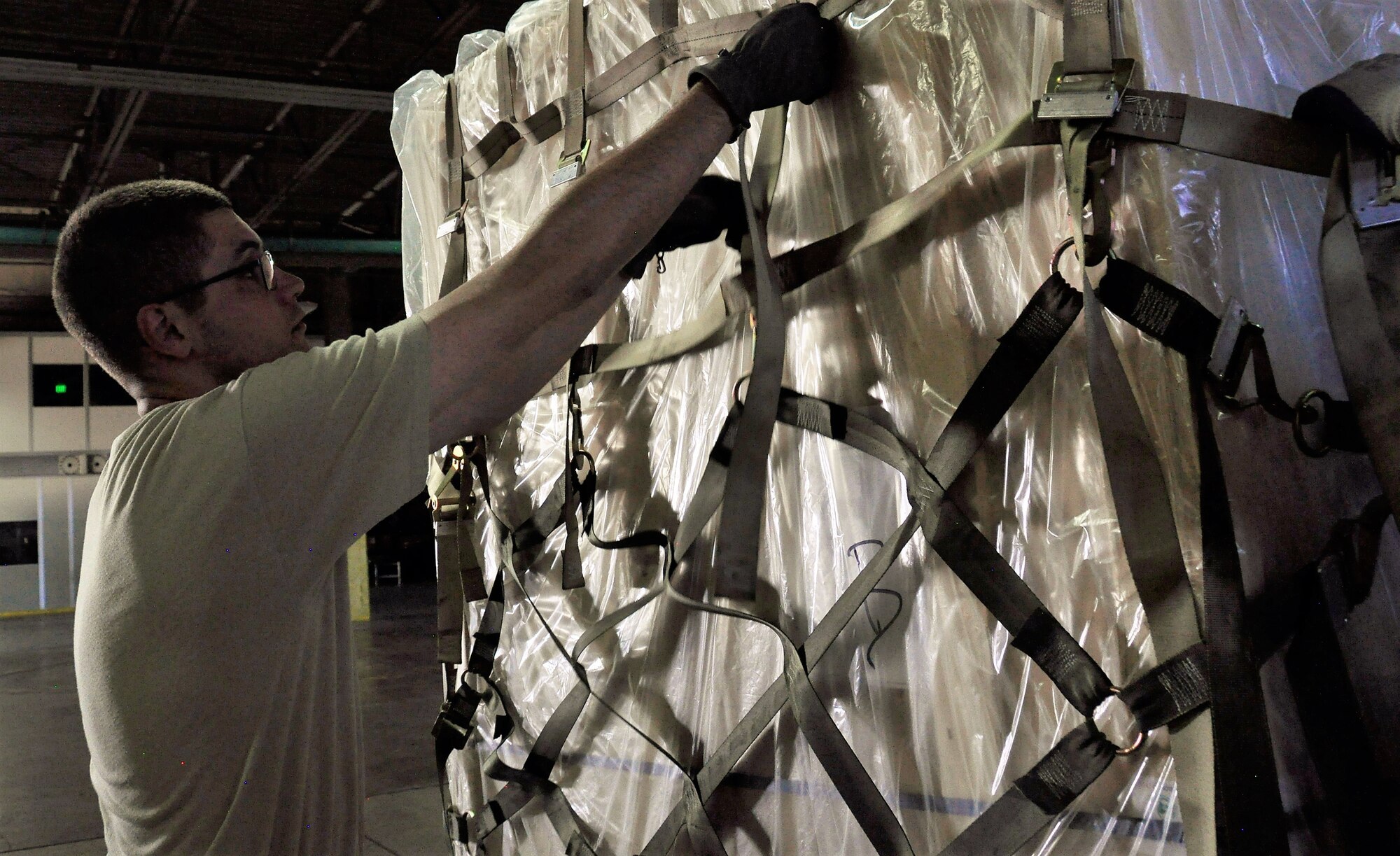 A 39th Aerial Port Squadron reservist secures netting around a cargo shipment during annual tour training at Travis Air Force Base, California, July 2017. The 39th APS was recently awarded the Air Reserve Component Air Transportation Activity of the Year in 2017 for outstanding contributions to the success of the Air Force and Department of Defense missions. (U.S. Air Force photo by Staff Sgt. Frank Casciotta)