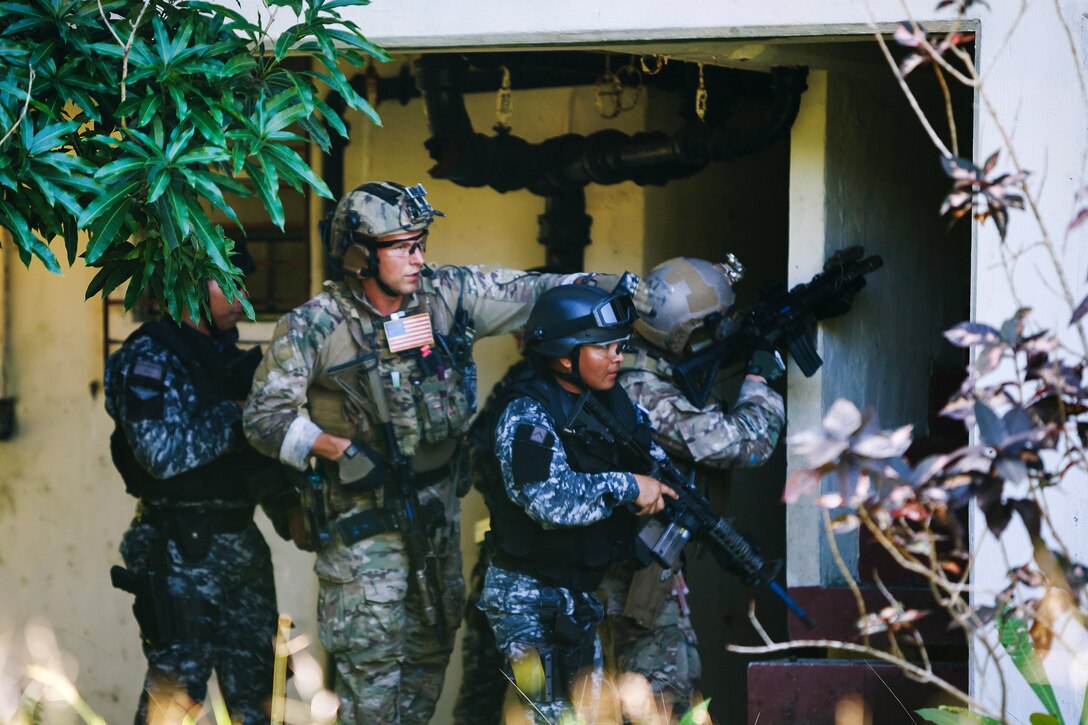 Special Forces soldiers prepare to clear buildings.
