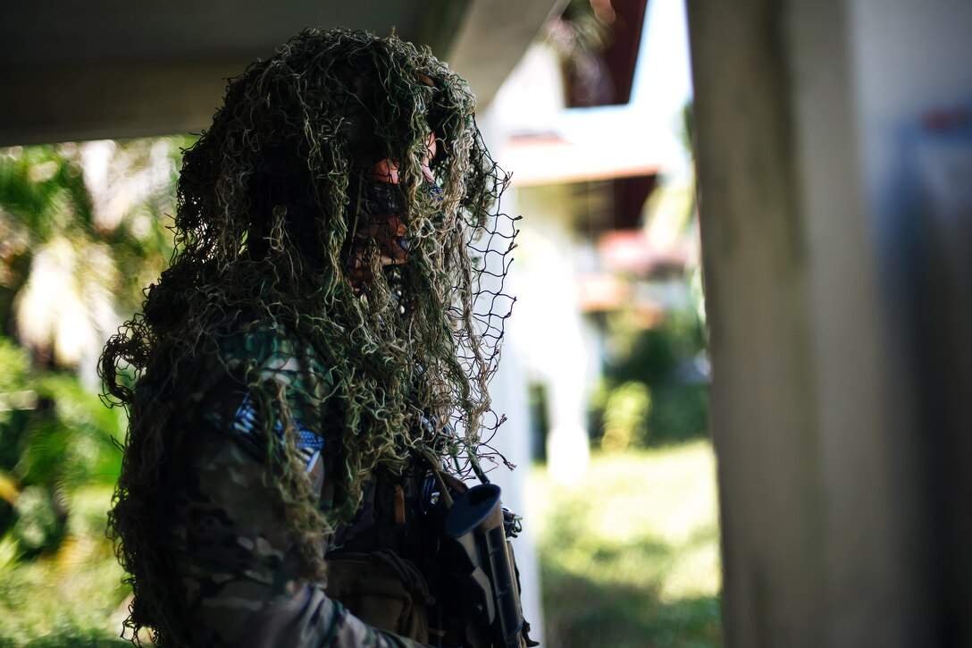 A Special Forces soldier observes reconnaissance training.