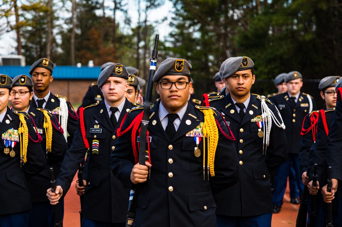 Students stand at parade rest while waiting for their final score following an Armed platoon exhibition during the North Springs Charter High School Invitational Drill Meet. U.S. Army Soldiers from the 335th Signal Command (Theater), and Georgia Recruiting Battalion, U.S. Army Recruiting Command served as judges and mentors for  Georgia area Junior Reserve Officer Training Corps (JROTC) students from 13 high schools at the North Springs Charter High School Invitational Drill Meet held in Atlanta, Feb. 24, 2018. (U.S. Army Reserve photo by Capt. David Gasperson)