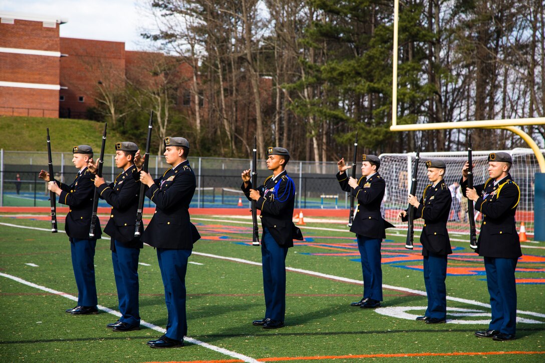 Students from Evans High School, Evans, Ga. perform a male armed squad exhibition during the North Springs Charter High School Invitational Drill Meet. U.S. Army Soldiers from the 335th Signal Command (Theater), and Georgia Recruiting Battalion, U.S. Army Recruiting Command served as judges and mentors for  Georgia area Junior Reserve Officer Training Corps (JROTC) students from 13 high schools at the North Springs Charter High School Invitational Drill Meet held in Atlanta, Feb. 24, 2018. (U.S. Army Reserve photo by Capt. David Gasperson)