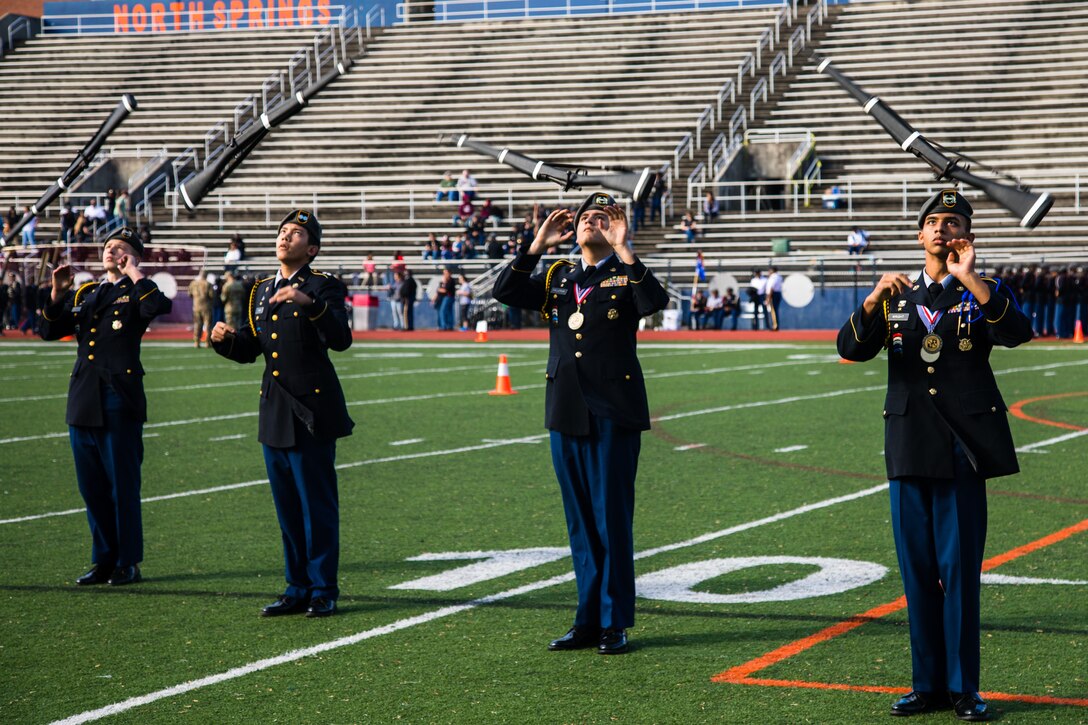 Students from Evans High School, Evans, Ga. perform a male armed squad exhibition during the North Springs Charter High School Invitational Drill Meet. U.S. Army Soldiers from the 335th Signal Command (Theater), and Georgia Recruiting Battalion, U.S. Army Recruiting Command served as judges and mentors for  Georgia area Junior Reserve Officer Training Corps (JROTC) students from 13 high schools at the North Springs Charter High School Invitational Drill Meet held in Atlanta, Feb. 24, 2018. (U.S. Army Reserve photo by Capt. David Gasperson)