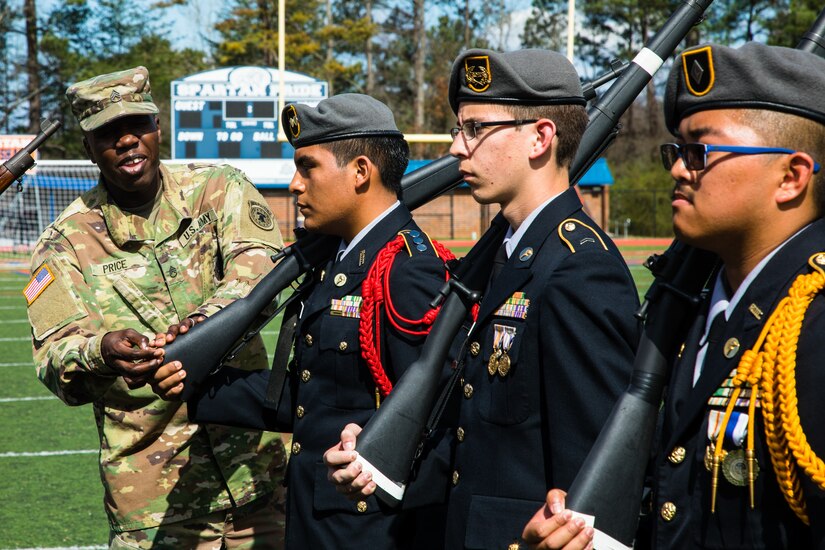 Staff Sgt. Norman Price, a recruiter with Georgia Company, Georgia Recruiting Battalion, U.S. Army Recruiting Command, inspects two JROTC students during a 'knock em out' drill and ceremony competition. Graders called out commands, and failure to produce the proper movement resulted in ejection from the competition. U.S. Army Soldiers from the 335th Signal Command (Theater), and Georgia Recruiting Battalion, U.S. Army Recruiting Command served as judges and mentors for  Georgia area Junior Reserve Officer Training Corps (JROTC) students from 13 high schools at the North Springs Charter High School Invitational Drill Meet held in Atlanta, Feb. 24, 2018. (U.S. Army Reserve photo by Capt. David Gasperson)
