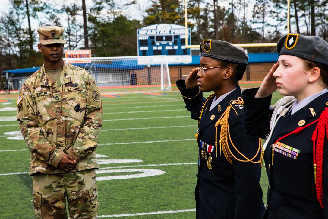 Sgt. 1st Class Trevor L. Boothe, a recruiter with Georgia Company, Georgia Recruiting Battalion, U.S. Army Recruiting Command, inspects hand salutes from two JROTC students during a 'knock em out' drill and ceremony competition. Graders called out commands, and failure to produce the proper movement resulted in ejection from the competition. U.S. Army Soldiers from the 335th Signal Command (Theater), and Georgia Recruiting Battalion, U.S. Army Recruiting Command served as judges and mentors for  Georgia area Junior Reserve Officer Training Corps (JROTC) students from 13 high schools at the North Springs Charter High School Invitational Drill Meet held in Atlanta, Feb. 24, 2018. (U.S. Army Reserve photo by Capt. David Gasperson)