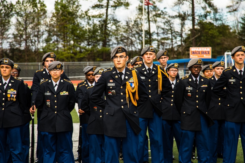 Cadet Justin Collado, a student at Grovetown High School, stands in front of the Grovetown High School Warriors Platoon during the awards ceremony of the North Springs Charter High School Invitational Drill Meet. Grovetown High School were named overall team champions of the event. U.S. Army Soldiers from the 335th Signal Command (Theater), and Georgia Recruiting Battalion, U.S. Army Recruiting Command served as judges and mentors for  Georgia area Junior Reserve Officer Training Corps (JROTC) students from 13 high schools at the North Springs Charter High School Invitational Drill Meet held in Atlanta, Feb. 24, 2018. (U.S. Army Reserve photos by Capt. David Gasperson)