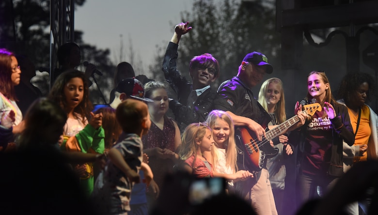 Gary Sinise, Lt. Dan Band founder, plays a song after inviting members of the crowd on stage during a concert at Tyndall Air Force Base, Fla., March 4, 2018. The Lt. Dan Band is a subset of numerous functions facilitated by the Gary Sinise Foundation. (U.S. Air Force photo by Airman 1st Class Solomon Cook/Released)