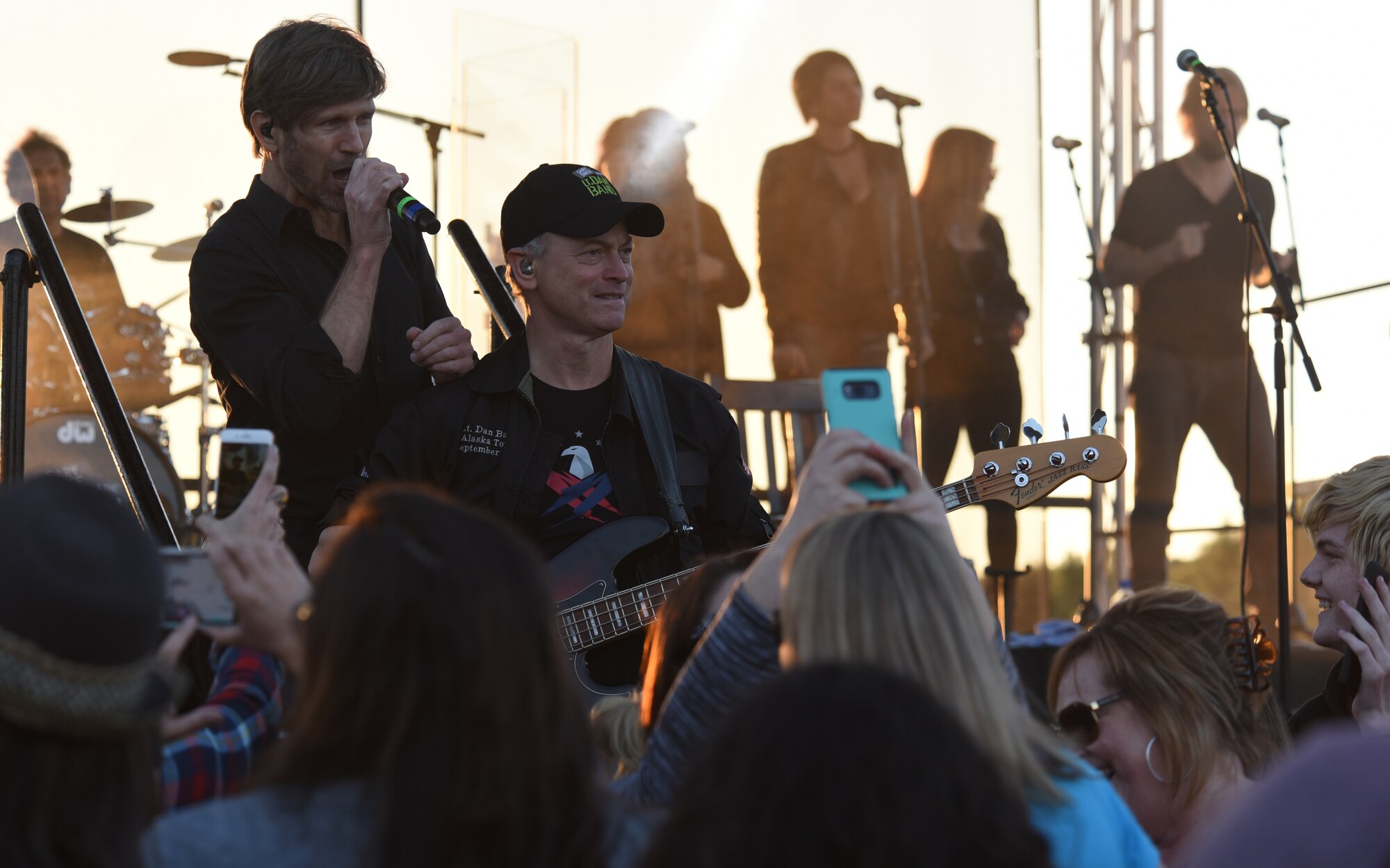 Jeff Vezain, Lt. Dan Band lead singer, sings a song while standing behind Gary Sinise, band founder, during a concert at Tyndall Air Force Base, Fla., March 4, 2018. (U.S. Air Force photo by Airman 1st Class Solomon Cook/Released)
