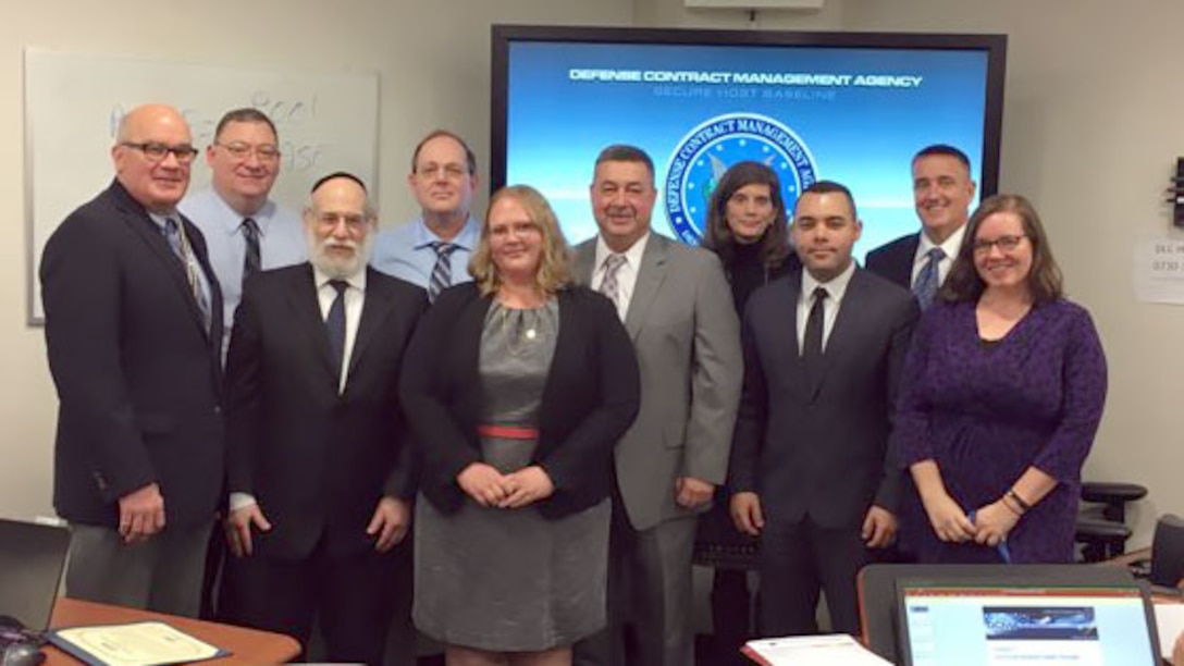 Michael Shields (center), executive director of Quality Assurance at the Defense Contract Management Agency, recently thanked the employees involved with the development of a new class, ENGR233, Technical Support to Indirect Costs. Employees (left to right): Christopher Brust; Anthony Labath; Stuart Harrow; Ken Pedeleose; Angelica Rogers; Shields; Julie Nesbit; José Ortiz; Kip Shepard; and Christina Payette. (DCMA photo by Harry Diaz Agosto)