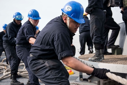 180312-N-DX072-038 SASEBO, Japan (March 12, 2018) Sailors handle a mooring line on the forecastle during a sea and anchor evolution as the amphibious transport dock ship USS Green Bay (LPD 20) prepares to depart Sasebo, Japan for deployment. Green Bay is operating in the Indo-Pacific region to enhance interoperability with partners and serve as a ready-response force for any type of contingency. (U.S. Navy photo by Mass Communication Specialist 2nd Class Anaid Banuelos Rodriguez/Released)