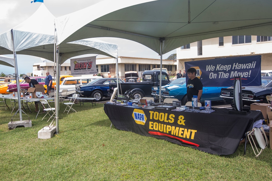 Various vendors provide services to those attending the Iron and Ink Festival hosted by Five-O-Motors, Marine Corps Base Hawaii, Feb. 24, 2018. The Iron and Ink Festival is an annual event for Service members and their family to enjoy a free car show with a tattoo contest, while also serving food and providing entertainment. (U.S. Marine Corps photo by Lance Cpl. Isabelo Tabanguil)