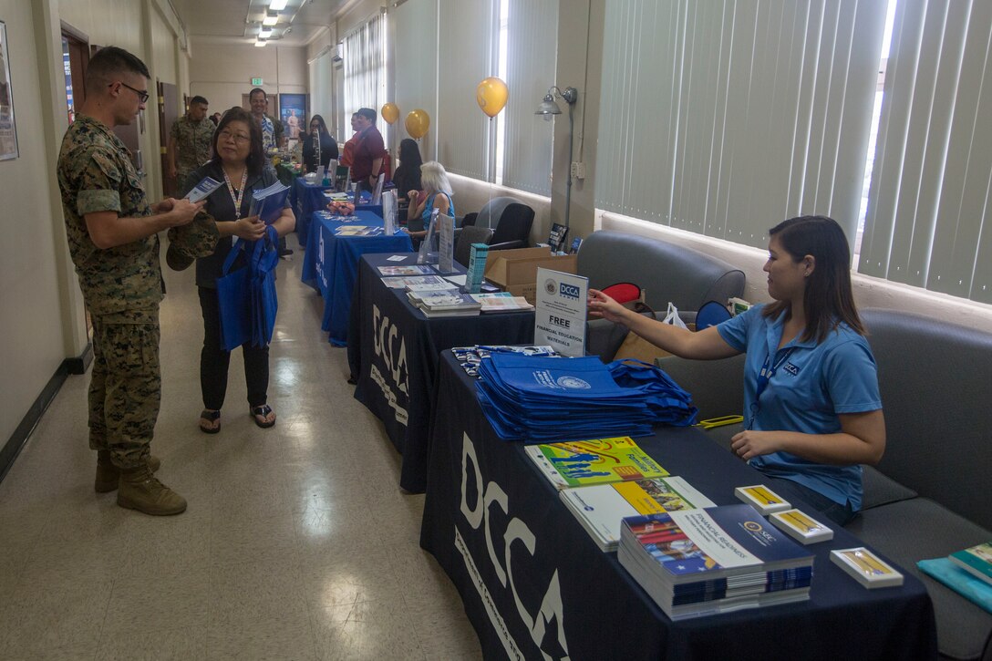 U.S. Marines and Sailors receive information from various vendors during the Personal and Professional Development Open House event at the Education Center, Marine Corps Base Hawaii, Feb. 27, 2018. The event involved numerous representatives from colleges, universities and organizations that provided educational opportunities exclusive to Service members. (U.S. Marine Corps photo by Lance Cpl. Isabelo Tabanguil)