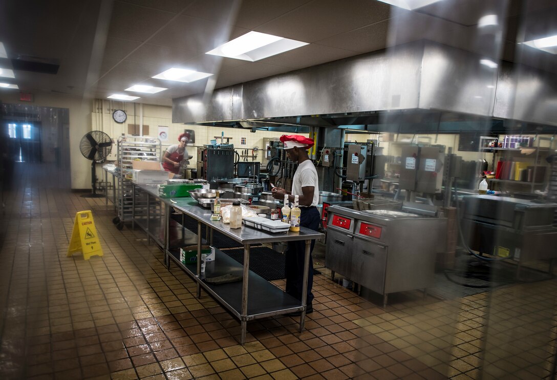 Airman 1st Class Tyrell Jackson prepares a dessert dish during a Top Chef competition March 8, 2018, at Magellan Inn Dining Facility, Andersen Air Force Base, Guam. Jackson is a services apprentice with the 36th Force Support Squadron and competed for the title of Top Chef of the Quarter with a chicken parmesan, accompanied by a apple-nougat dessert. (U.S. Air Force photo by Staff Sgt. Alexander W. Riedel)