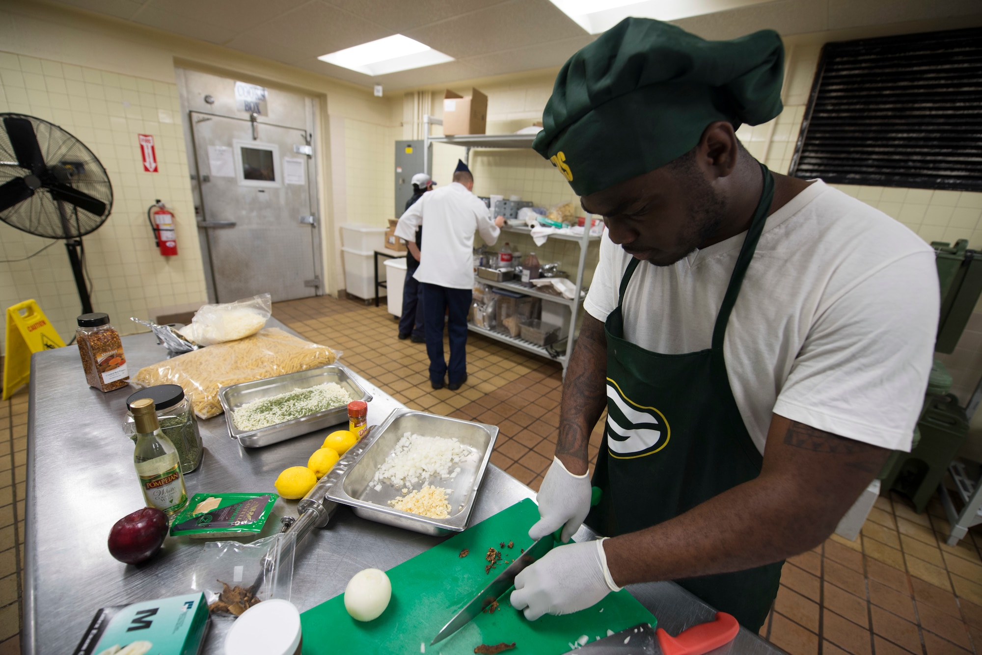 U.S. Army Specialist Kevron Usher, culinary specialist with Task Force Talon's E Battery, 3rd Air Defense Artillery Regiment, cuts dried mushrooms March 8, 2018, at Magellan Inn Dining Facility, Guam. Usher and his team support service members assigned to Andersen AFB and neighboring Northwest Field facilities. (U.S. Air Force photo by Staff Sgt. Alexander W. Riedel)