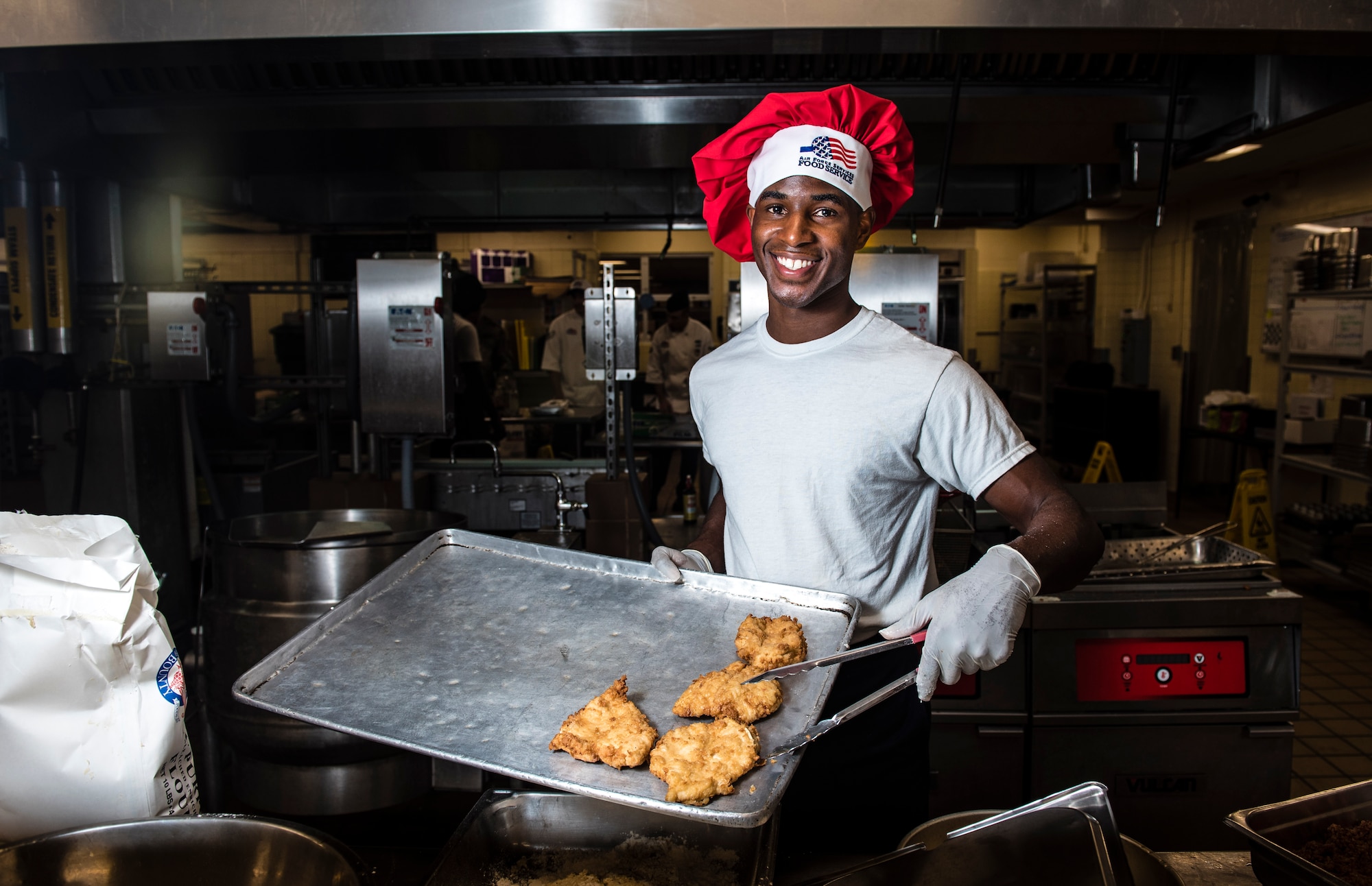 Airman 1st Class Tyrell Jackson presents his chicken parmesan batch during the Andersen Top Chef competition March 8, 2018, at Magellan Inn Dining Facility, Andersen Air Force Base, Guam. Jackson is a services apprentice and competed for the title of Top Chef of the Quarter by preparing a chicken parmesan dish. (U.S. Air Force photo by Staff Sgt. Alexander W. Riedel)
