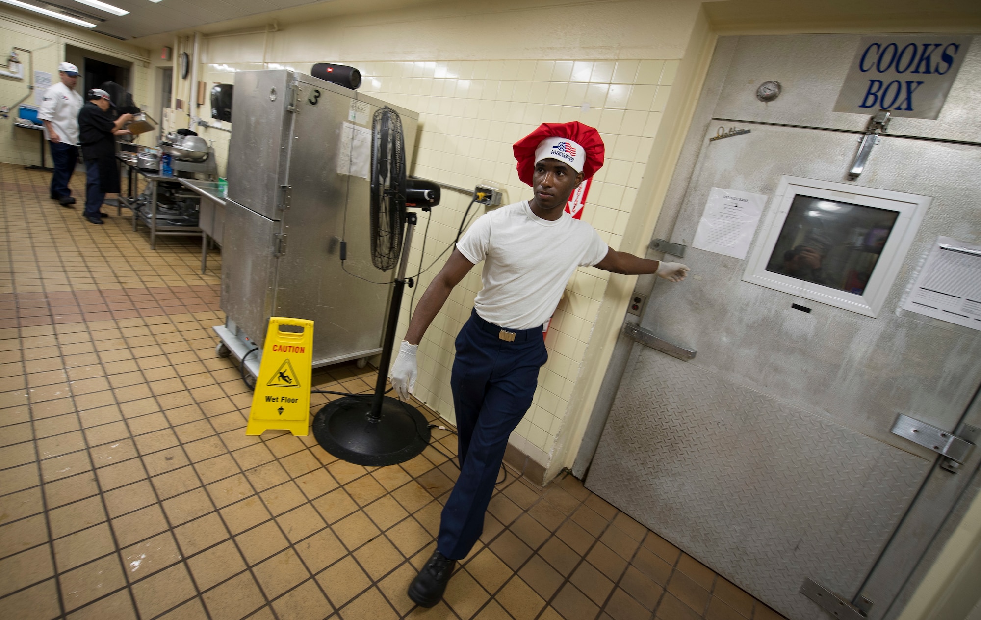 Airman 1st Class Tyrell Jackson closes the door to the "Cooks Box" freezer during a Top Chef competition March 8, 2018, at Magellan Inn Dining Facility, Andersen Air Force Base, Guam. Jackson is a services apprentice and competed for the title of Top Chef of the Quarter against fellow AIr Force and U.S. Army culinary specialists. (U.S. Air Force photo by Staff Sgt. Alexander W. Riedel)