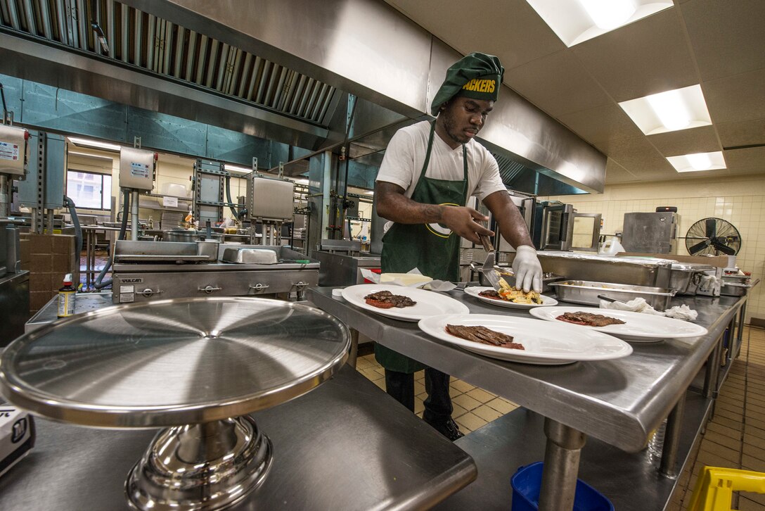 U.S. Army Specialist Kevron Usher, culinary specialist with Task Force Talon's  E Battery, 3rd Air Defense Artillery Regiment,  arranges ingredients of a meal during a Top Chef competition March 8, 2018, at Magellan Inn Dining Facility, Anderen Air Force Base, Guam. Usher prepared Italian steak with panini pasta and tomato sauce. Competitors' dishes were judged by a panel of Air Force, Army and civilian leaders in a variety of grading categories. (U.S. Air Force photo by Staff Sgt. Alexander W. Riedel)