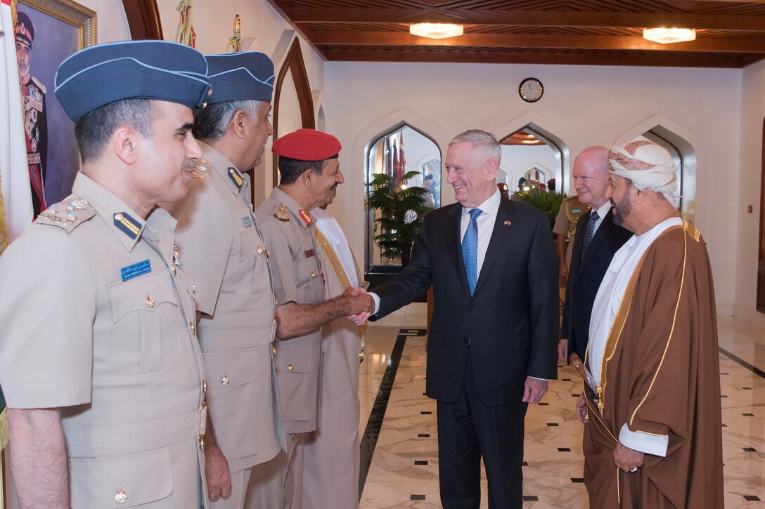 Defense Secretary James N. Mattis shakes hands with Omani service members.