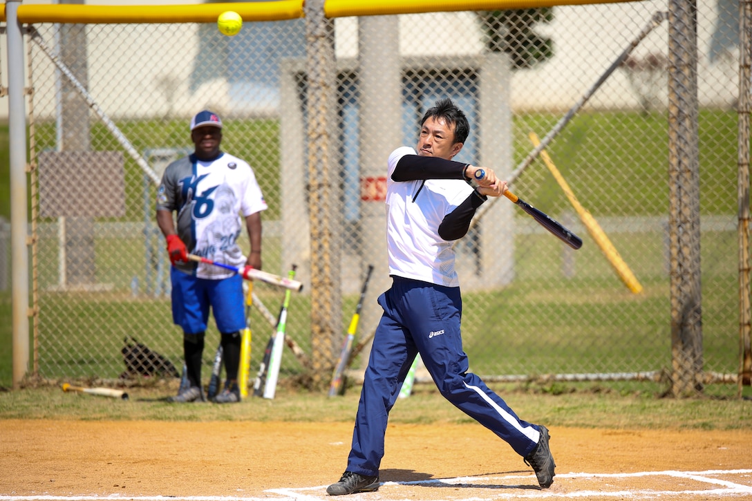 A batter from the Japan Ground Self-Defense Force team prepares to hit a ball during a Camp Commanders Cup softball tournament March 10 aboard Camp Kinser, Okinawa, Japan. The tournament invited members of the JGSDF 15th Brigade on base for a day of laughs, food and friendship. Two teams from JGSDF played in the tournament with members from Combat Logistics Regiment 35 and Headquarters Regiment. (U.S. Marine Corps photo by Pfc. Nicole Rogge)