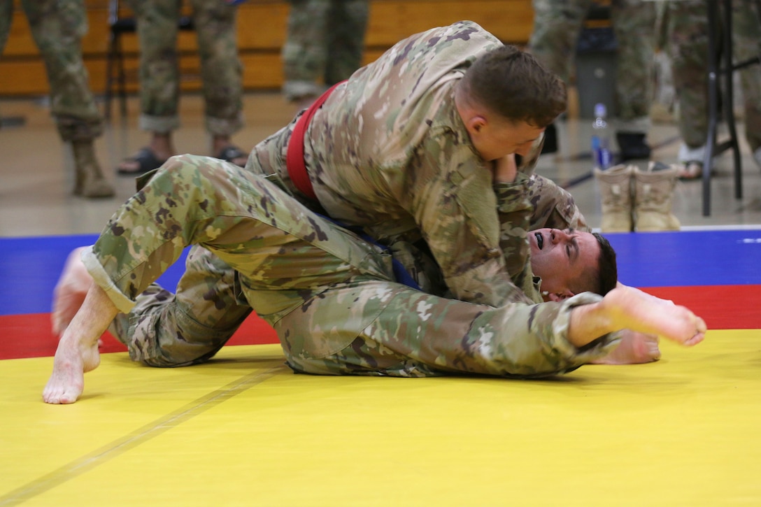 Soldiers grapple for a submission position.