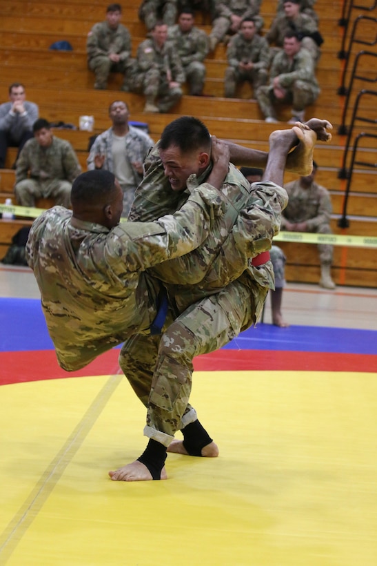 A soldier takes down his opponent.