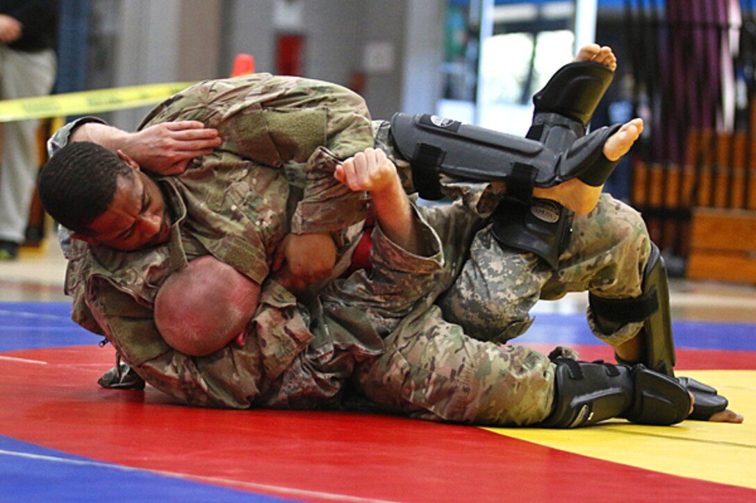Soldiers grapple for a submission position.