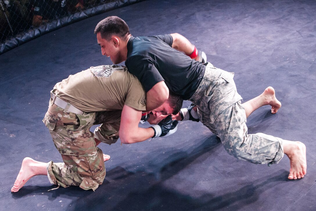 A soldier attempts a submission hold on his opponent.