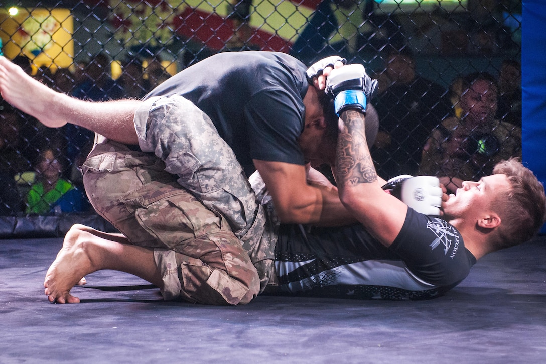 A soldier has the upper advantage hold on his opponent.